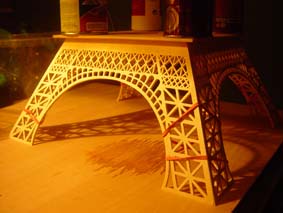 first section of the Eiffel Tower wooden model held with elastic bands