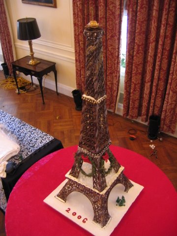 Cake Eiffel Tower model on table dressed in red