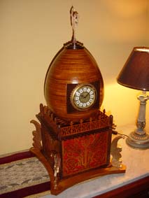 scroll saw fretwork egg clock by a table lamp with a black shade