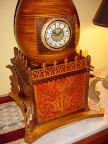 fretwork egg clock with red felt and four golden wingeg sphinxs