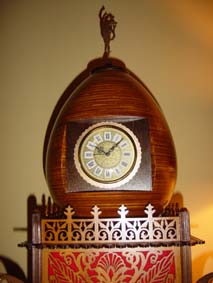 scroll saw egg clock with red felt in the fretwork sides