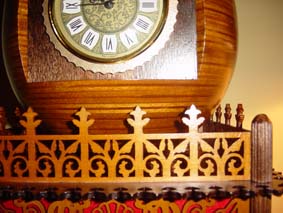 fretworked wooden fence around the scroll saw egg clock